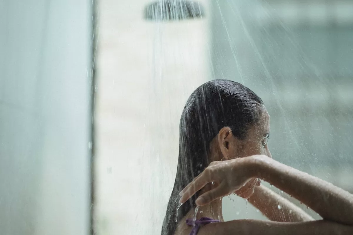 Femme qui lave ses cheveux sous la douche